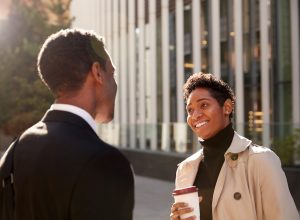smiling woman talking to a businessman