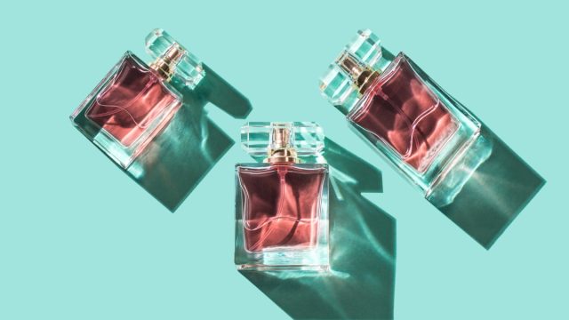 Pattern,Bottles,Of,Woman,Perfume,On,A,Turquoise,Background,,Top