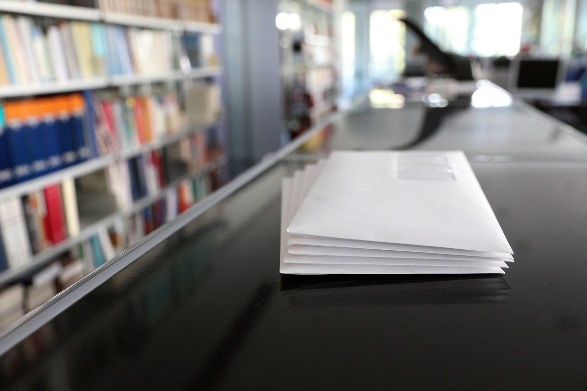 Stacks of white mail envelopes in office