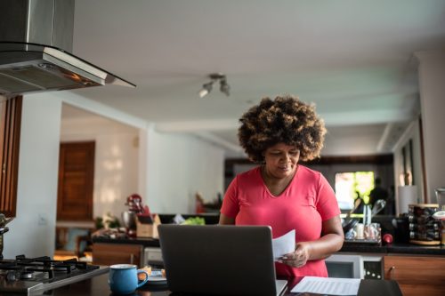 Mature woman doing finances and working at home