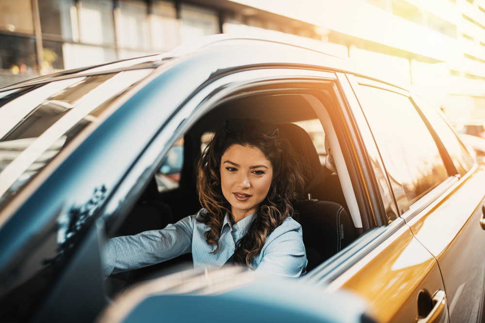 A young woman driving a car