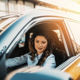 A young woman driving a car