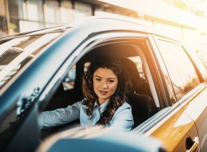 A young woman driving a car