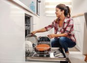 A woman unloading a dishwasher in the kitchen