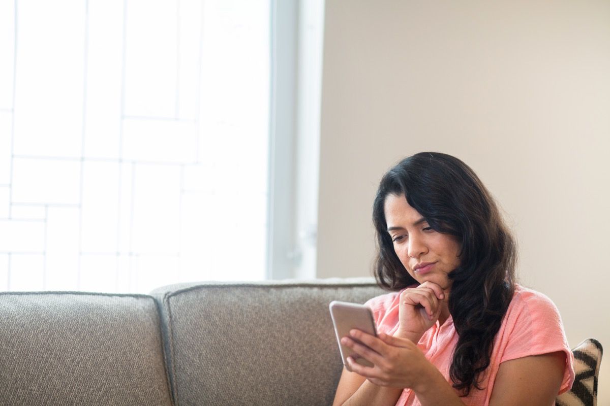 woman reading messages on her phone.