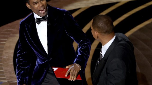 chris rock reacts to being slapped by will smith onstage at the academy awards