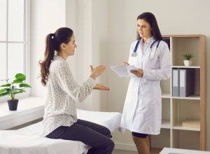Woman talking to female doctor