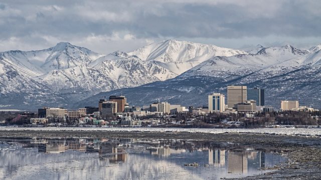 The skyline of Anchorage, Alaska with mountains in the background