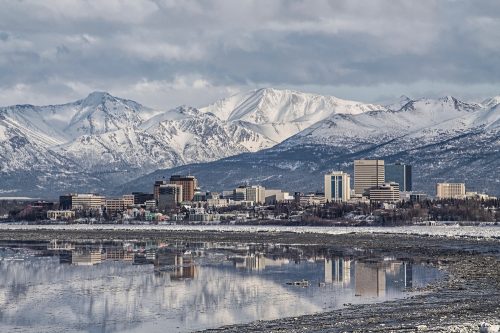 The skyline of Anchorage, Alaska with mountains in the background