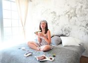 woman crying and eating in bed
