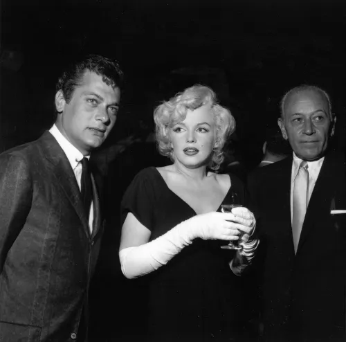 Tony Curtis and Marilyn Monroe at a party in 1958