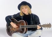 Debbie Gibson posing with a guitar in 1988