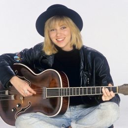 Debbie Gibson posing with a guitar in 1988