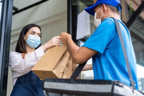 Food deliverly man wear protective mask due to Covid-19 pandemic