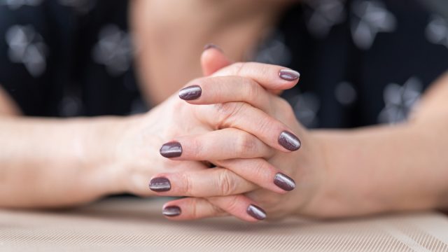 woman's hands with painted nails