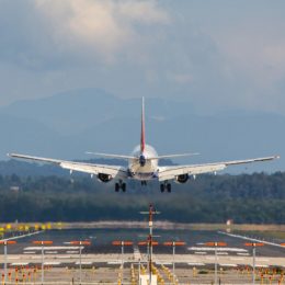 A passenger jet plane landing on a runway at an airport