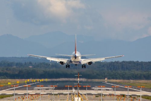 A passenger jet plane landing on a runway at an airport
