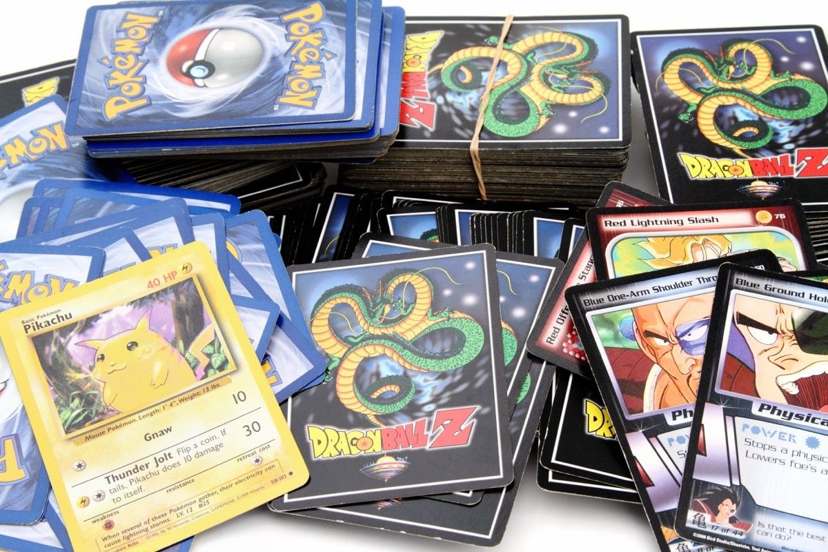 product shot of an assortment of Dragon Ball Z and Pokemon trading game cards. Pokemon trading cards are produced by Nintendo.The Dragon Ball Z cards are based on the Japanese Dragon Ball animation series created by Akira Toriyama. Dragon Ball Z cards are produced by Bird Studio/Shueisha and licensed by Funimation.