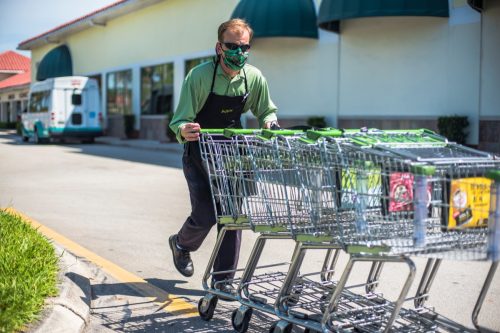 Publix Grocery Store Worker Returning carts To Store From parking lot with Face Mask