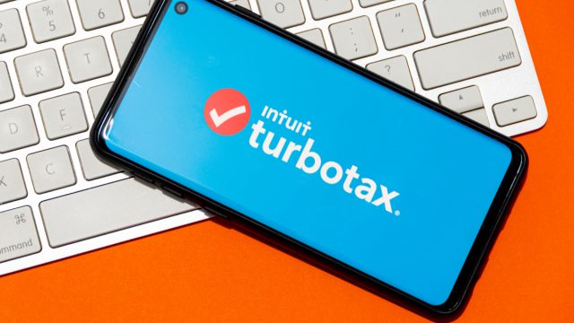 TurboTax on phone with a keyboard in the background