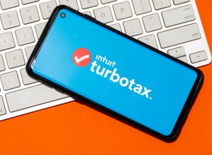 TurboTax on phone with a keyboard in the background
