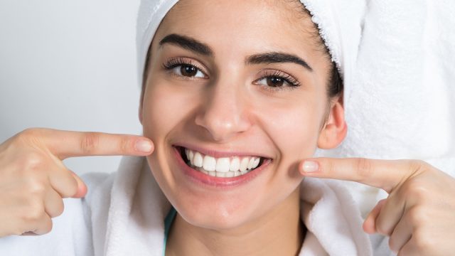 Closeup,Portrait,Of,Happy,Female,Showing,Clean,Teeth,At,Home