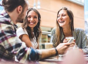 friends laughing around a table