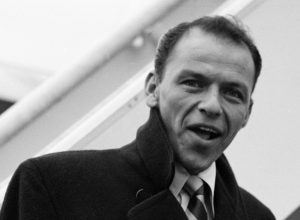 Frank Sinatra boarding a flight from London to New York in 1952