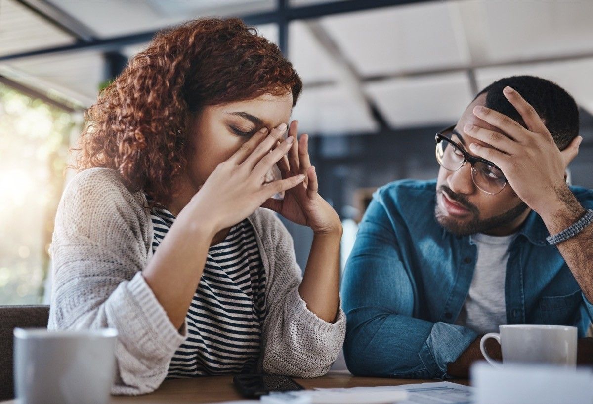 Shot of a young couple looking stressed out while working on their budget at home