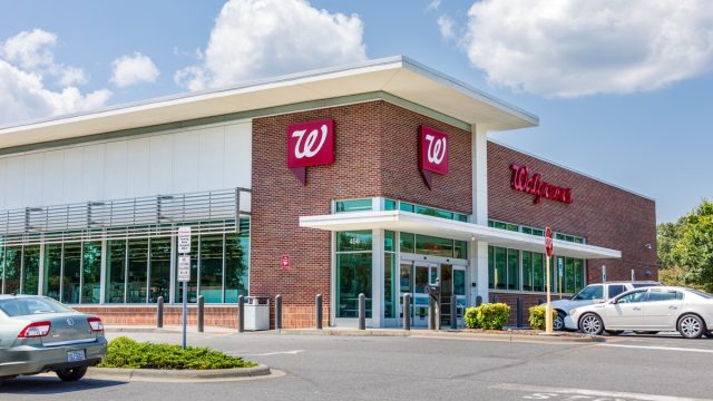 A Walgreens Pharmacy, bulding and parking lot.