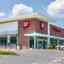 A Walgreens Pharmacy, bulding and parking lot.