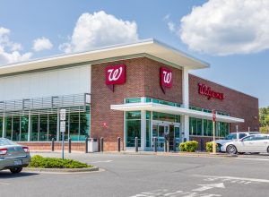 A Walgreens Pharmacy, bulding and parking lot.
