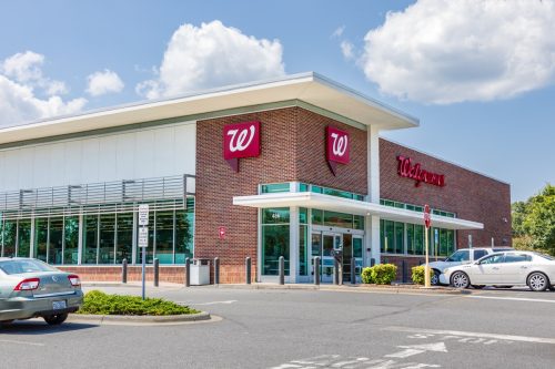 A Walgreens Pharmacy, bulding and parking lot.
