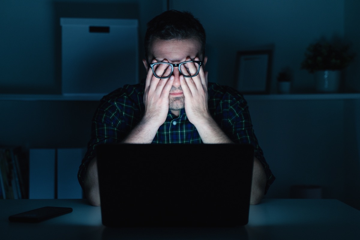 Man with poor night vision looking at computer