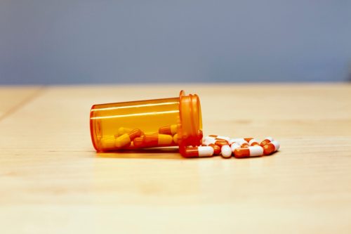Healthcare medication orange bottle with pill drugs