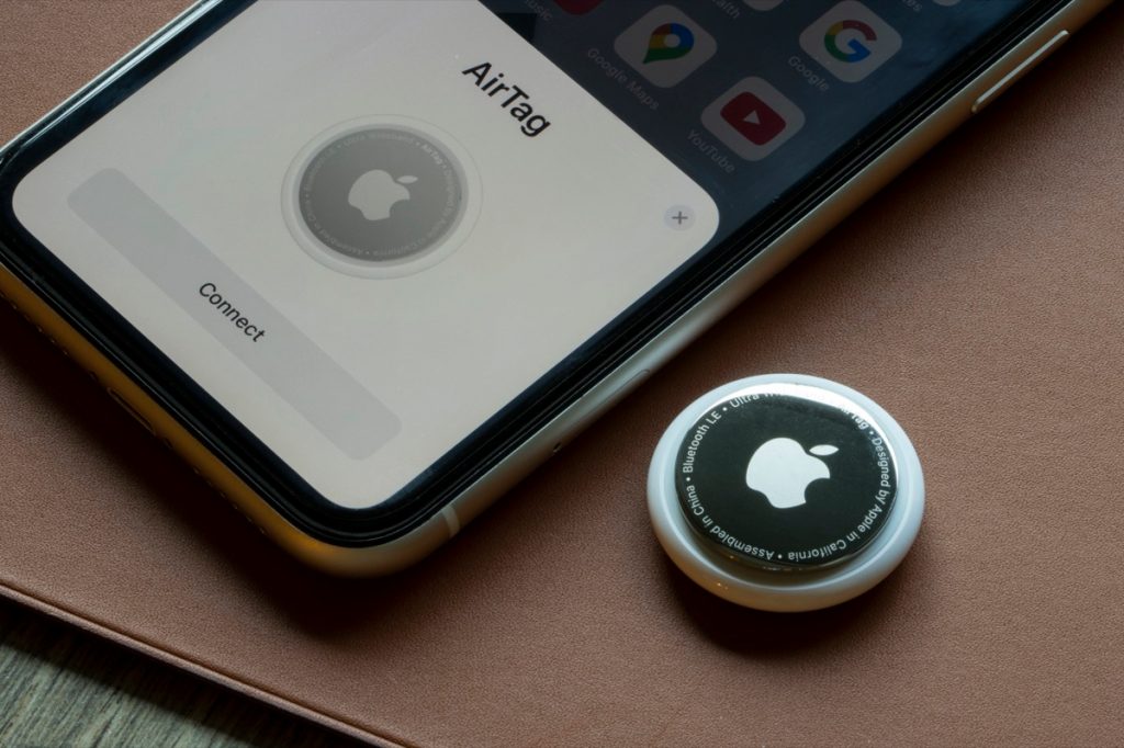 An AirTag is seen being connected to an iPhone. AirTag is a tracking device developed by Apple.