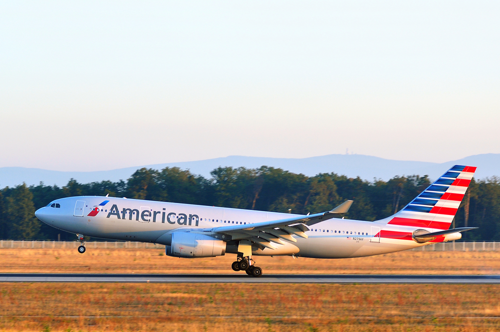 An American Airlines plane landing on a runway
