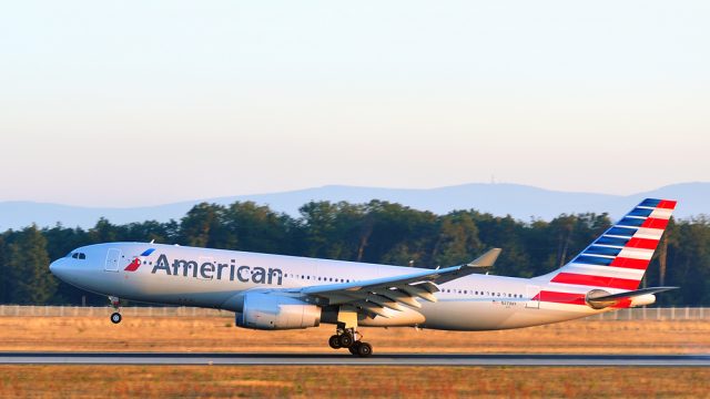 An American Airlines plane landing on a runway