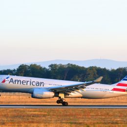 An American Airlines plane landing on a runway