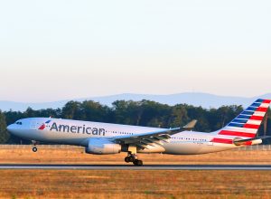An American Airlines plane landing on a runway