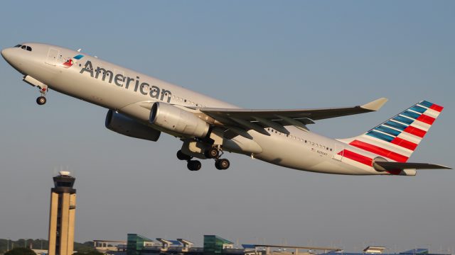 An American Airlines plane taking off from an airport runway