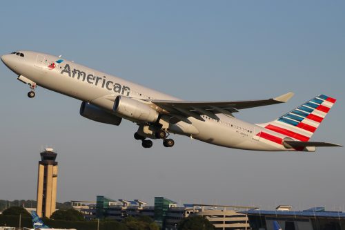 An American Airlines plane taking off from an airport runway