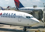 Delta Airlines passenger jet arrives at a gate at Hartsfield-Jackson Atlanta International Airport.
