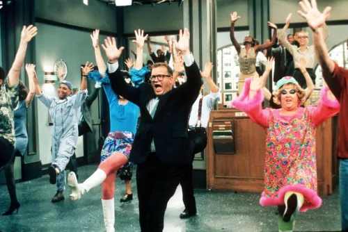 Drew Carey, Kathy Kinney, and other cast members dancing on "The Drew Carey Show"