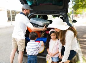 A family packing their car to take a road trip