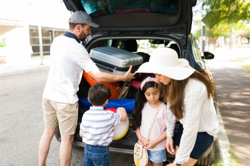 A family packing their car to take a road trip