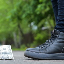 girl finding dollar in street