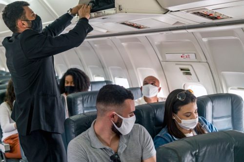 Photo of passengers flying using protective face masks.