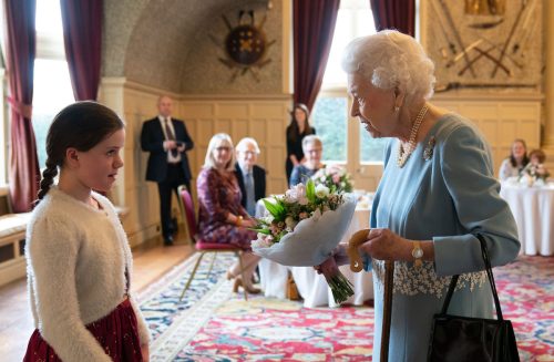 Queen Elizabeth speaking to a child during a reception celebrating the start of her Platinum Jubilee on February 5, 2022