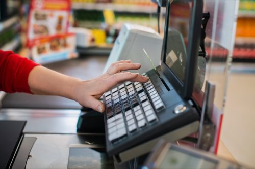 cashier typing on keypad